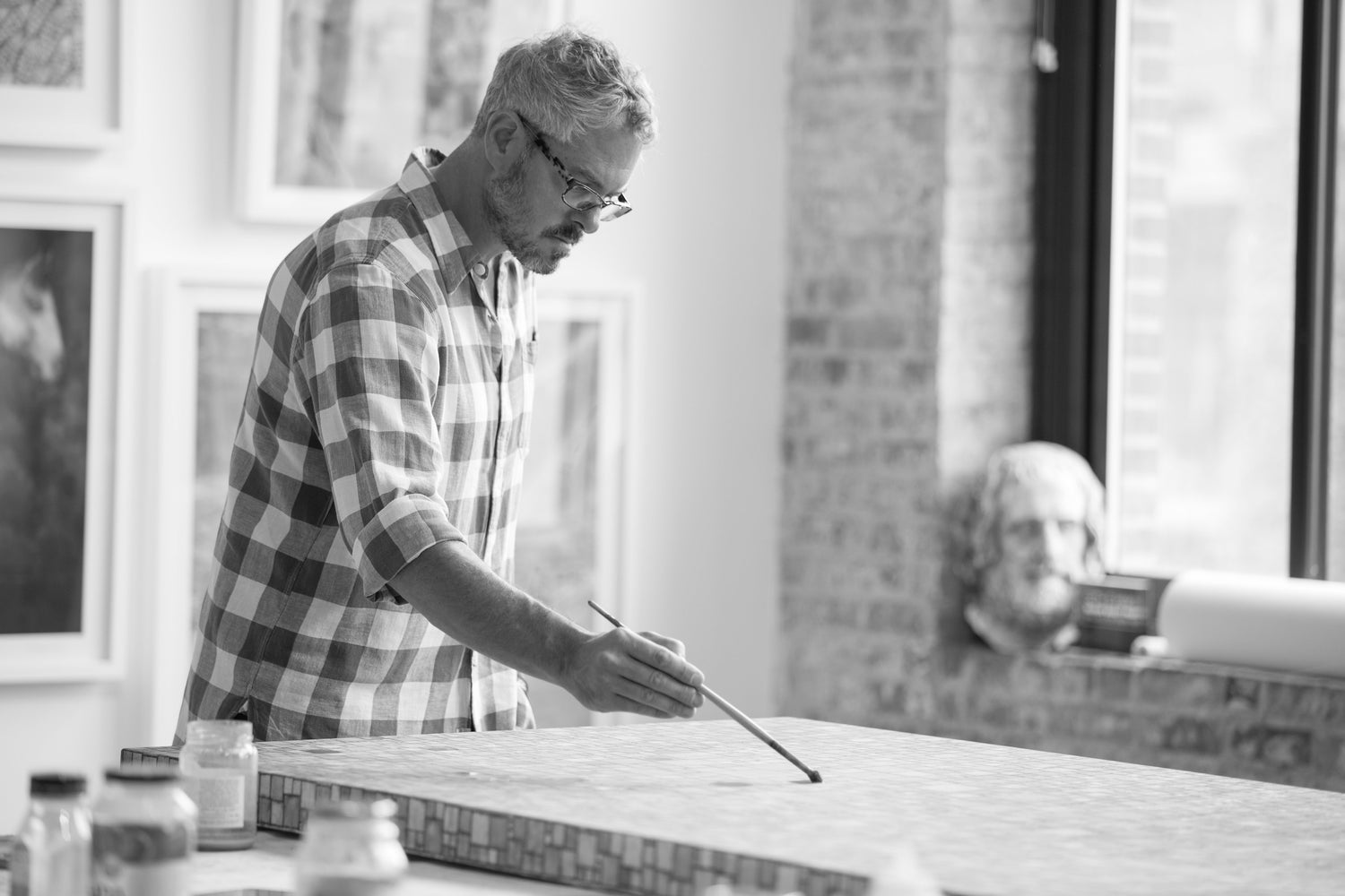 The image shows seth b minkin working on an oil on canvas original painting in his studio in south boston